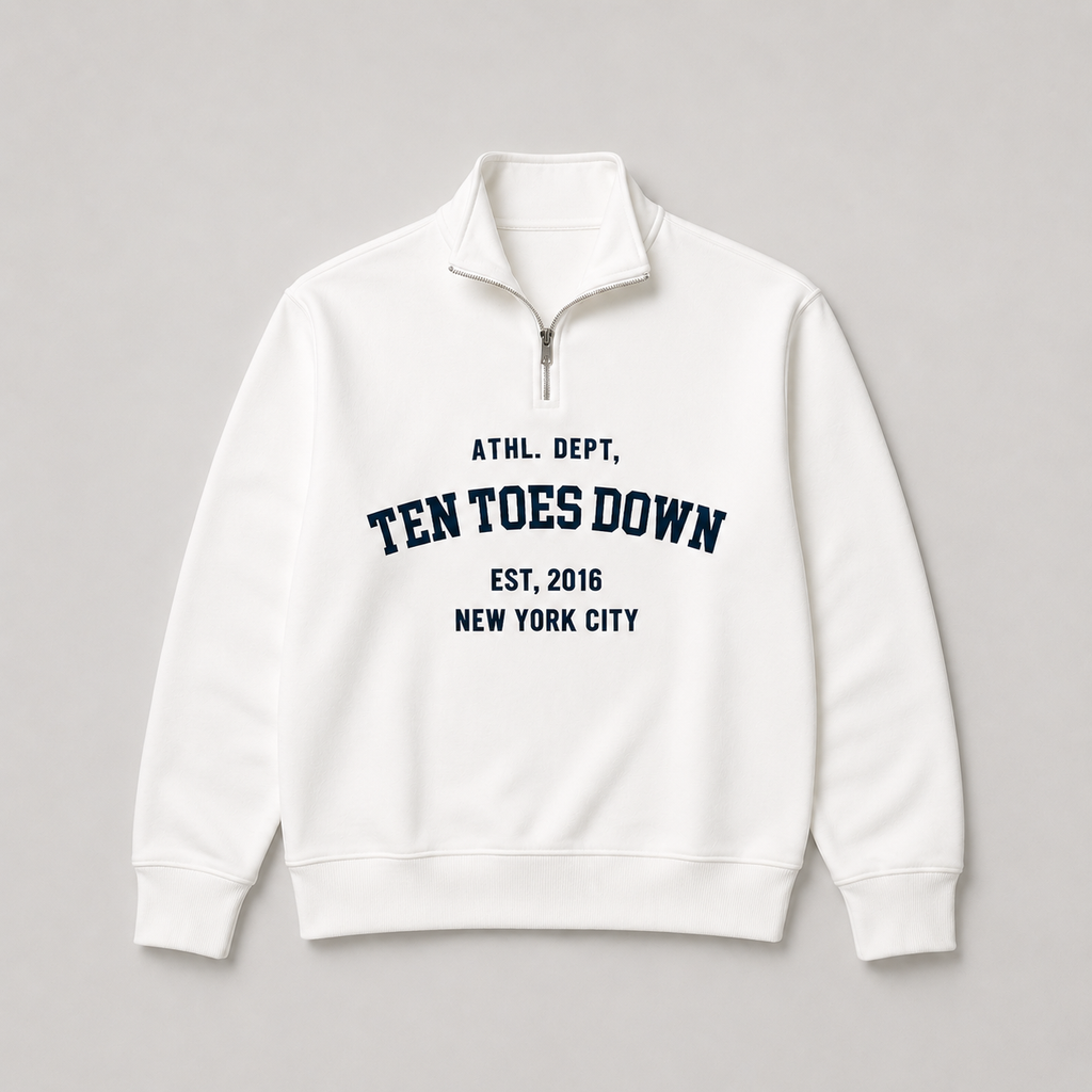 A white quarter-zip sweatshirt with navy blue collegiate-style oversized text reading 'TEN TOES DOWN'