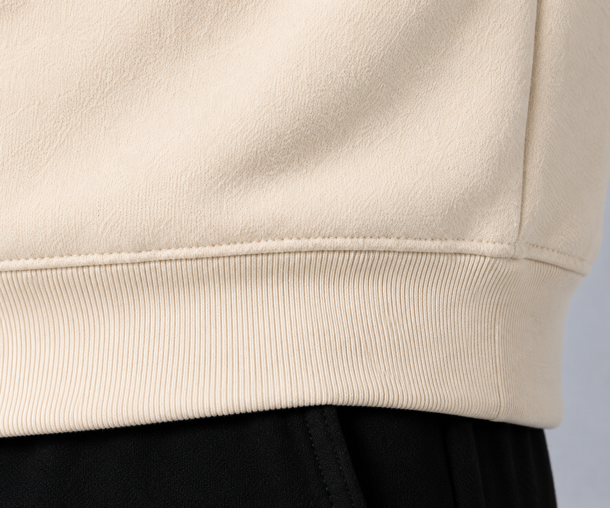 Close-up of ribbed hem on Ten Toes Down Cream Standard Quarter Zip